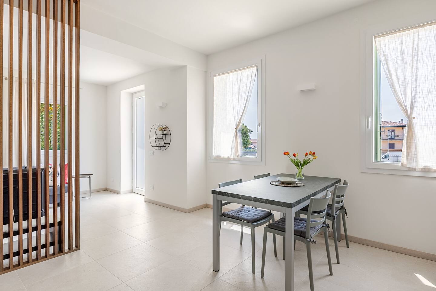Sala da pranzo luminosa con due finestre